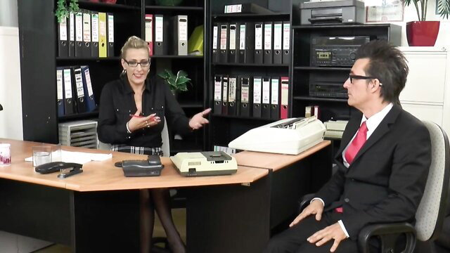 Blonde milf secretary in skirt talking at office desk interview