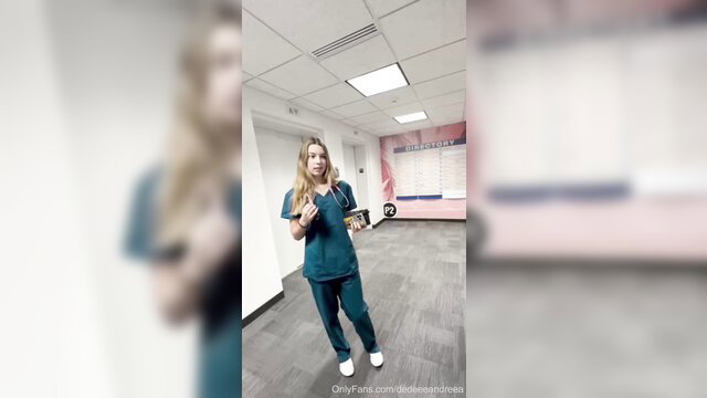 Blonde nurse in scrubs surprised in hospital hallway