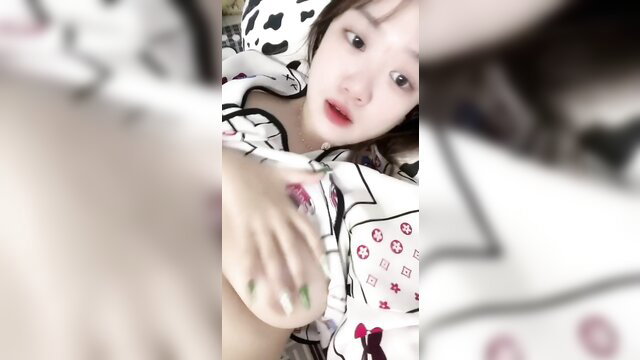 Beautiful Asian babe in white lingerie on bed, cute face closeup