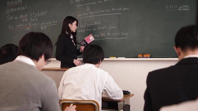 Japanese teacher in suit lectures male students in classroom JAV scene