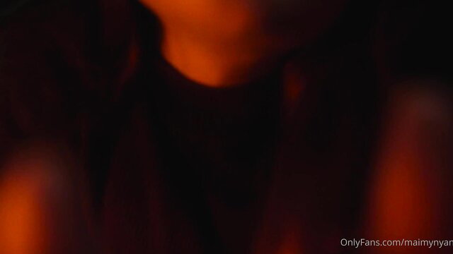 Blurry closeup of woman's neck and shoulders in warm glow cozy night ASMR