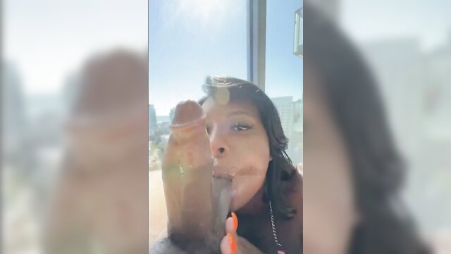 Latina babe teasing huge dildo outdoors by window