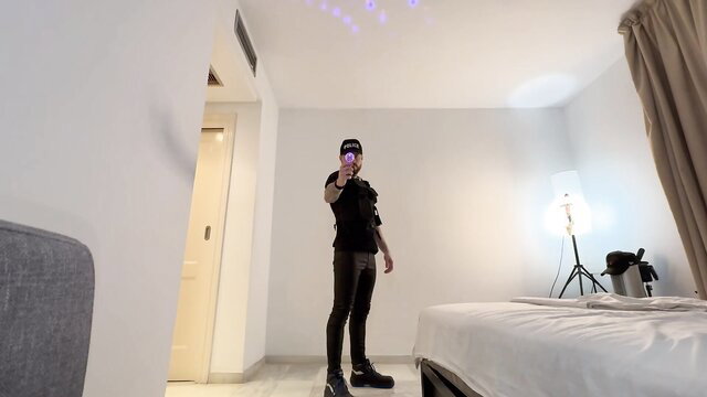 Onlymaxdennison in tight black outfit, posing as giant cop in shrink fetish scene