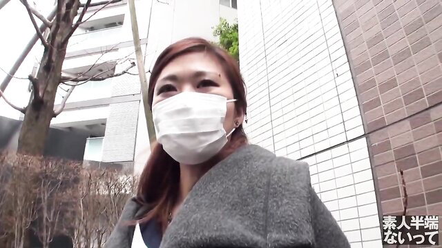 Bored Japanese woman in mask and coat outside JAV thumbnail