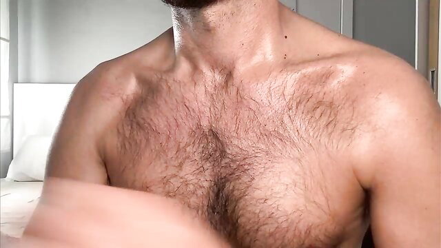 Hairy Latino otter dude flexing sweaty muscled chest closeup