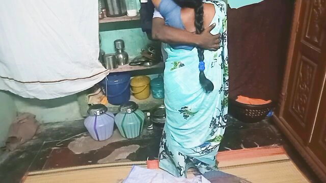 Indian aunty in blue saree hugged from behind by student in home