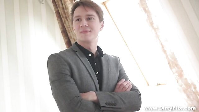 Handsome young Russian guy in suit smirking confidently
