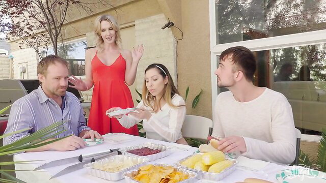 Mason Lear with blondes in red dress at outdoor table party