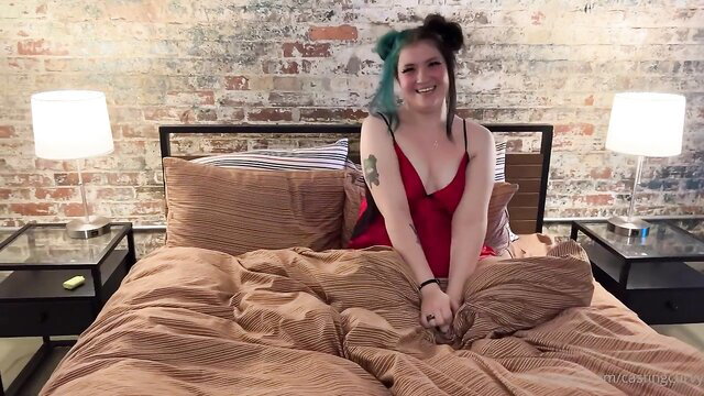 Smiling curvy amateur in red lingerie on bed POV tease