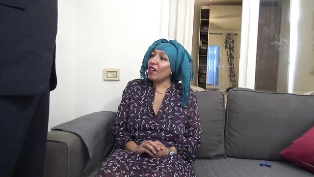 Souzan Halabi in hijab on couch with suited man, rough Kurdistan XXX