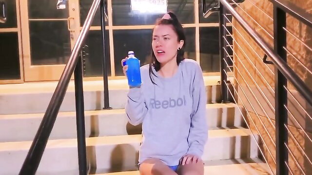 Asian girl in Reebok sweatshirt horny wetting jean shorts outdoor stairs
