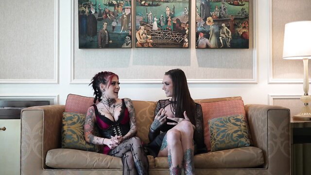 Rocky Emerson and Hawk chat on couch in lingerie tattoos