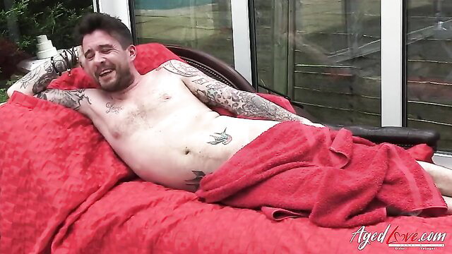 Tattooed British cougar mature blonde sucking model dick closeup