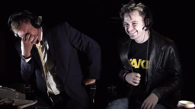 Fakehub Originals bloopers: suited man laughing with young guy in leather jacket