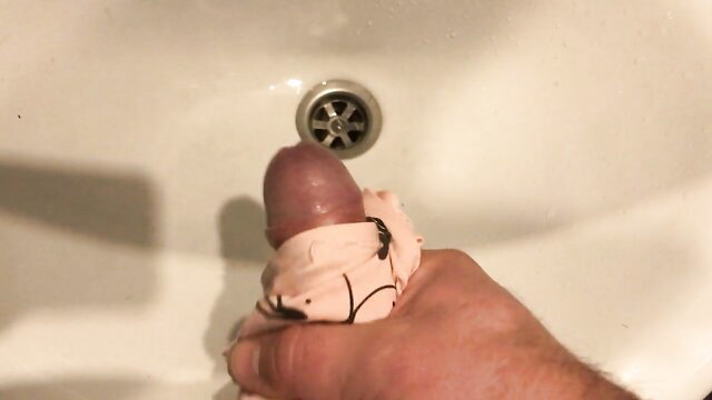 Man's erect cock wrapped in stepmom's pink messy panties at sink
