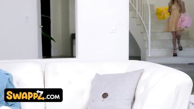 Two hot girls in sexy dresses on white couch, lesbian swap tease