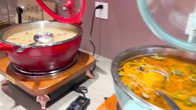 Asian buffet soup pots steaming at Chinese restaurant counter