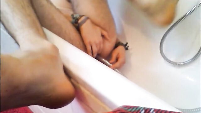 Twink uses shower head for enema in tub, masturbates solo
