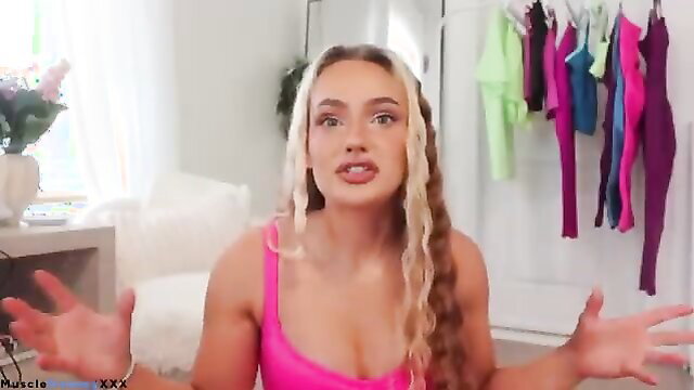 Blonde content creator in pink tank top, expressive vlog pose
