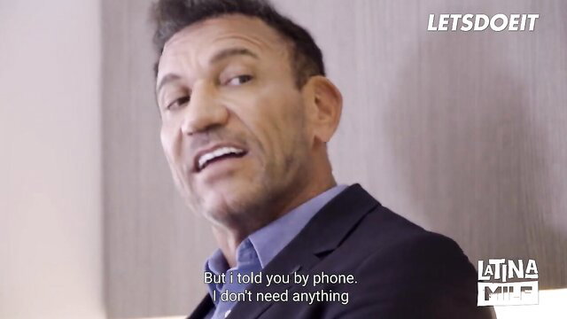 Briana Banderas smirks confidently in suit, Latina MILF thumbnail