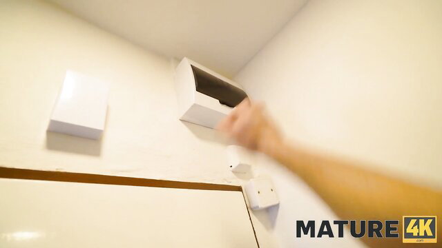 Mature busty woman grabbing huge tits in POV closeup