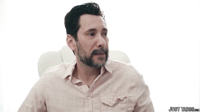 Handsome mature man with beard in pink shirt, closeup interview style