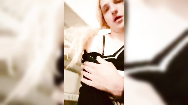 Blonde sissy Cum1ra grabs tits in sexy lingerie closeup