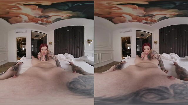 Redhead tattooed MILF teases huge tits and pussy on bed