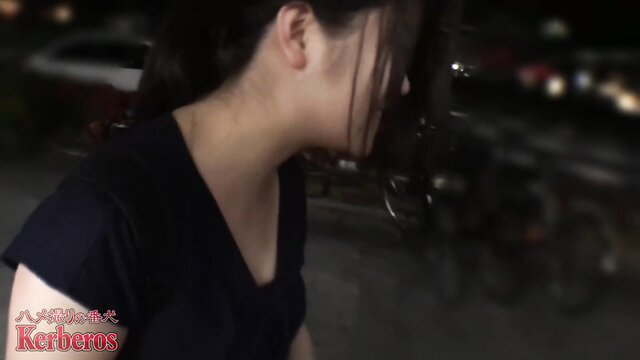 Asian girl in black top, profile view, outdoors at night