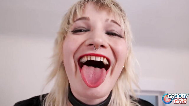Grooby Girls blonde tgirl with nose ring sticks out tongue laughing