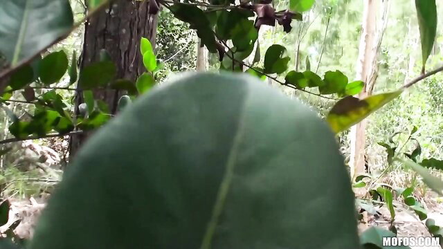 Busty MILF hides behind leaves in sneaky outdoor tease