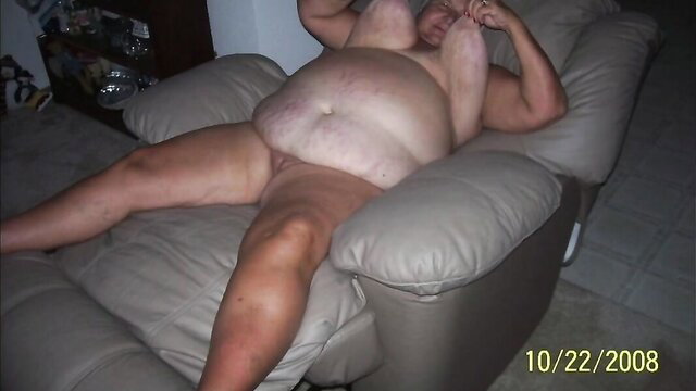 Nude obese mature granny lounging naked in chair, free HD facial video thumbnail