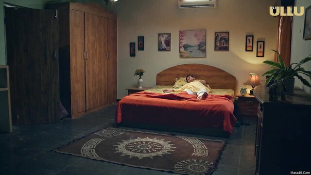 Desi Indian woman lying topless on bed in steamy web series scene