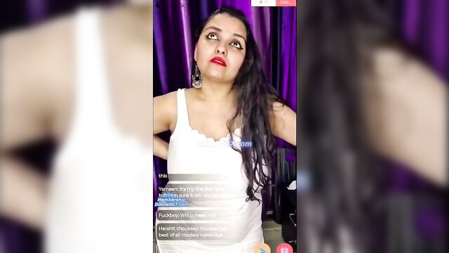 Indian beauty in white tank top poses seductively with hands on hips