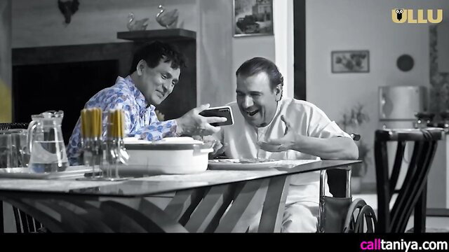 Mera Sasur Rasiya Ep4: Two Indian men laughing at phone over dinner table