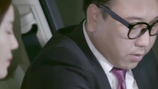 Asian woman and suited man in tense car scene from Young Lady 2015 uncut