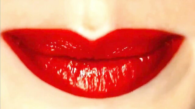 Shiny red glossy lips smiling seductively close-up
