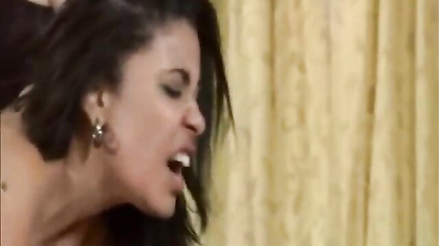 Closeup of black woman grimacing in ecstasy during lesbian discipline scene