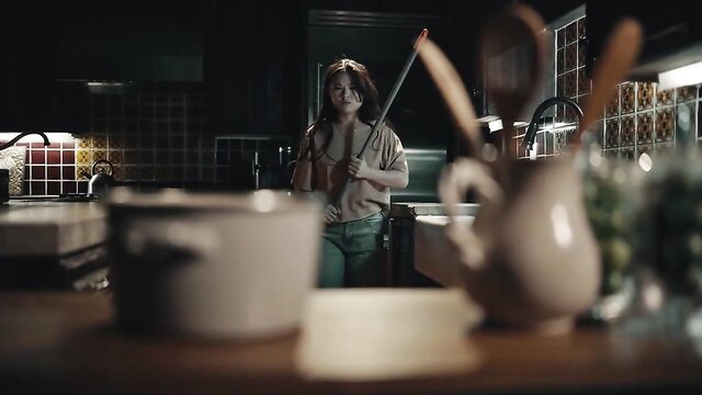 Lexi Lore in kitchen holding mop, Lulu Chu not visible