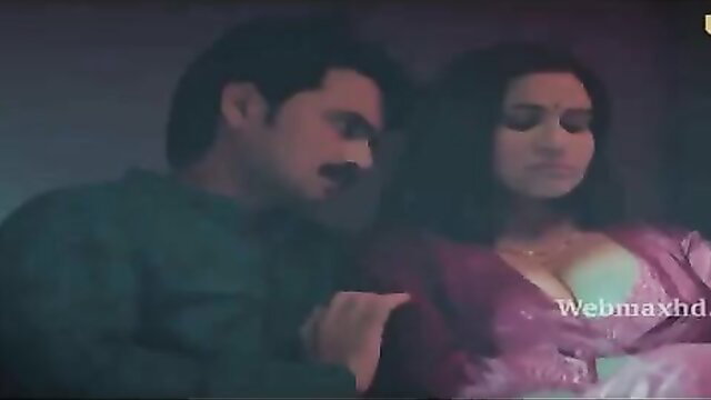 Indian couple intimate moment, busty woman in deep purple dress with man