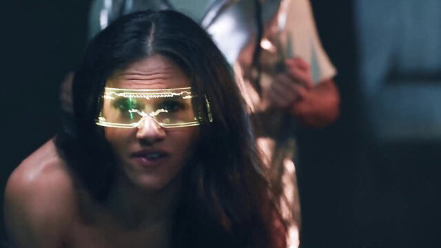 Penny Barber in neon glasses closeup, Max Fills behind in sensual action