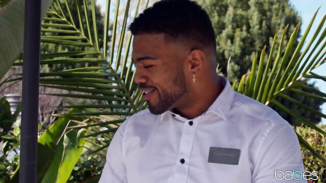 Man smiling in a tropical setting
