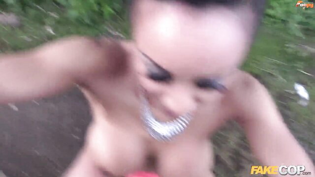 Nude black woman with grillz smiles big tits exposed in outdoor Fake Cop scene