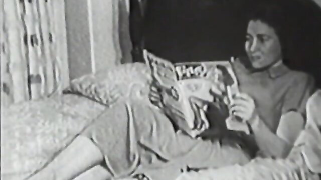 Vintage brunette reading newspaper on bed in classic stag film Cover Girl