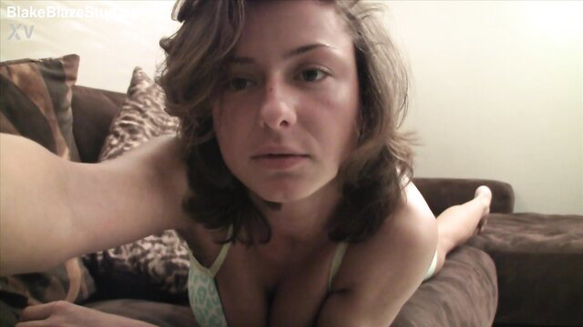 Sandra Wellness in lingerie on couch, teasing cleavage solo