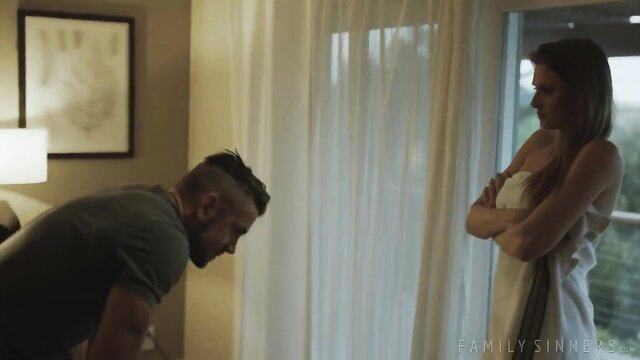 Ashley Lane arms crossed in lingerie facing stepbrother kneeling