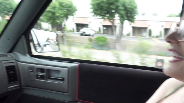 Blonde Riley Rose in car smiling at camera, amateur tease