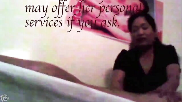 Asian masseuse in black top offers personal services during erotic massage