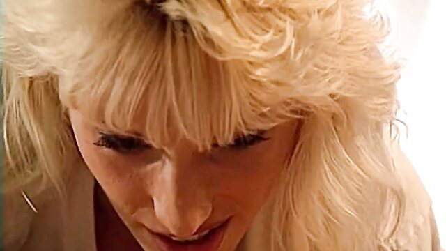 Close-up of blonde pornstar Debi Diamond smiling seductively