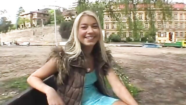 Sweet Czech blonde girl in blue dress on outdoor bench